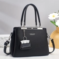 Detail of black lychee grain leather handbag with silver hardware and adjustable strap - Black