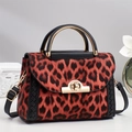 Fashionable leopard print crossbody bag with brown faux fur and gold clasp hardware - Red