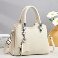 Close-up of beige lychee leather tote bag with silver hardware and star charm detail - Off-white