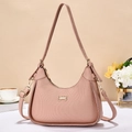 Detail of nude pink pleated leather handbag with golden bow buckle and fashion hardware - Pink