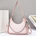 Detail of pink shoulder bag with monogram texture and silver metal chain strap - Pink
