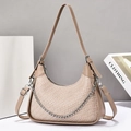Detail of khaki crescent crossbody bag featuring textured panel and silver chain strap - Khaki