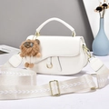 White saddle bag with gold ring buckle, wide woven strap and brown plush charm detail - White