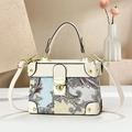 Retro paisley print box handbag with cream leather trim and gold metal clasp in elegant setting - White