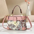 Detail of pink paisley patchwork handbag with golden hardware and leather handle - Pink