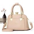 Detailed shot of beige pebbled leather tote with golden twist lock and logo - Light Khaki