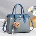 Fashionable textured handbag for women in blue with gold buckle and bear charm - Blue