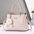 Light pink faux leather handbag with embossed letters and a white plush pompom charm - Pink
