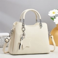 Chic beige lychee pattern tote bag with star charm and silver hardware on a display pedestal - Off-white