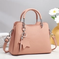 Detail of dusty pink textured leather tote bag with silver hardware and star charm - Pink