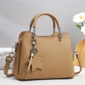 Detail of khaki pebbled leather tote bag with star pendant and silver hardware - Khaki