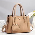 Minimalist nude pleated leather handbag with gold hardware and mini charm on stone base - Khaki