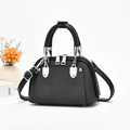Vue détaillée du sac à main noir avec texture tressée et détails en métal argenté - Noir