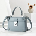Elegant light blue leather box handbag with silver rivets and metal clasp hardware - Blue
