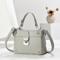 Elegant light gray lychee grain leather handbag with silver metal lock and top handle - Gray