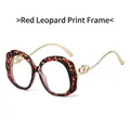 Occhiali leopardati rossi con bordi ondulati e aste dorate con cuori metallici - Montatura Leopardata Rossa