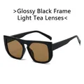 Lunettes de soleil carrées oversize en noir brillant avec verres teintés thé léger - Monture Noire Verre Thé Clair