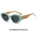Gafas de sol cat-eye con montura verde té, lentes gris oscuro y patillas marrón claro - Montura Té Verde Lentes Gris Negro
