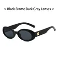 Gafas de sol ovaladas clásicas con montura negra brillante y detalles dorados - Montura Negra Lentes Gris Negro
