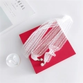 Elegant white lace scarf with pearl drop pendants displayed on a red gift box - White Lace Print / 6-150cm
