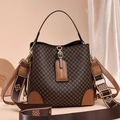 Close-up of monogram bucket bag featuring gold buckle and woven logo shoulder strap - Style 5 Argyle Coffee