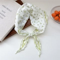 Lightweight white silk scarf with green floral pattern tied in a decorative bow style - Green Leaf Border