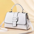 White crocodile pattern handbag with handle and adjustable strap in minimalist studio setting - Off-white