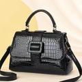 Elegant black crocodile embossed handbag with top handle and adjustable shoulder strap - Black