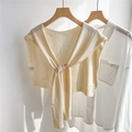 Detail of light beige knitted shawl capelet layered over a white shirt on a wooden hanger - 43*100CM / Beige