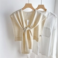 Detail of cream yellow knitted shawl showing ribbed edges and branded tag on white shirt - Off White