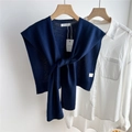 Detailed knit texture of dark blue shawl knotted over a white shirt on wooden hanger - Navy Blue