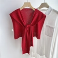 Close-up of red knitted shawl with sparkling sequins layered over a white shirt - Red