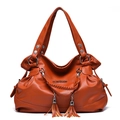 Orange-brown lychee texture tote bag with braided handle and tassel details - Yellow Brown