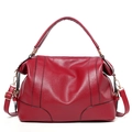 Elegant red leather handbag with top handles and adjustable strap in a 45-degree angle - Burgundy