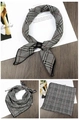 Detail of houndscarf with black and white plaid pattern and a black leather loop fastener - Black & White Fine Stripes