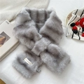 Detail showing the plush faux fur texture and brand label of the grey striped scarf - Gray