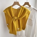 Close-up of ginger yellow 100% wool knit shawl with hollow geometric patterns and a front knot - Yellow