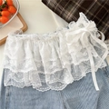 Dettaglio di gonna in pizzo floreale bianco stile balletto con fiocco in seta su denim - Bianco a Pois a Più Strati