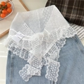 Close-up of white lace neckerchief with floral embroidery and mesh details on denim - Wave Flower Style