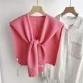 Detail of pink knitted shawl with crochet texture and ribbon tie on white shirt - Peach