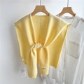 Close-up of a yellow hollow-out knit shawl featuring delicate crochet floral texture - Light Yellow