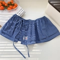 Close-up of blue and white plaid layered ruffle skirt extender with decorative tie details - One Size / Navy Blue Plaid (2 Lattice Long Rope Navy)