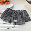 Detail of black and white checkered skirt layer with drawstring and red accent label - One Size / Black Plaid (4 Lattice Long Rope Black)