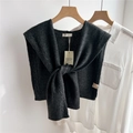 Detail of 100% wool knit shawl in dark grey showing texture and brand label - 43x100cm / Black and Gray