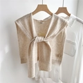 Detail of chunky cable knit 100% wool beige shawl draped over a white shirt with tie knot - 43x100cm / Beige