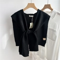Detail of black cable-knit 100% wool shawl layered over a white long-sleeve shirt - 43x100cm / Black