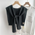 Detail of dark gray wool knit shawl with button, styled over a white shirt - 43x110cm / Black and Gray