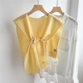Detail of light yellow 100% wool knitted shawl layered over a white long sleeve shirt - 43x110cm / Light Yellow