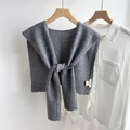 Detail of grey wool knitted shawl with 100% wool label over a white shirt - 43x110cm / Gray
