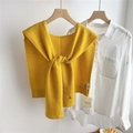 Detail of yellow wool knit shawl tied over a white shirt on a wooden hanger - 43x110cm / Dark Yellow